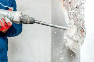 Удаляют наслоения при помощи перфоратора 